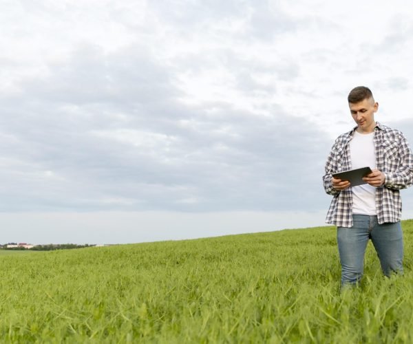 low-angle-man-with-tablet-farm